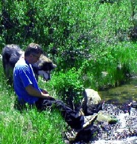 John sits with Sky by Sagehen Creek